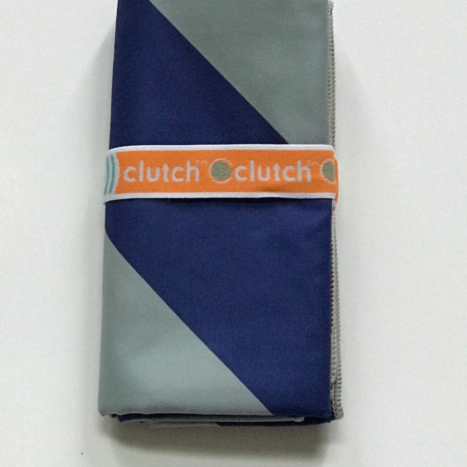 Folded 32″×64″ Clutch Towels oversized towel with bold navy and gray zig-zag pattern, soft and absorbent. Available at Be Charmed