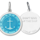 Front & Back of A sterling silver Lola pendant in light blue with an enamel inlay in the shape of an anchor and a circular design, featuring the engraved text 'DON'T GIVE UP THE SHIP.'. BAvailable at Be Charmed