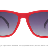 Red sunglasses with dark lenses on a white background. Available at Be Charmed