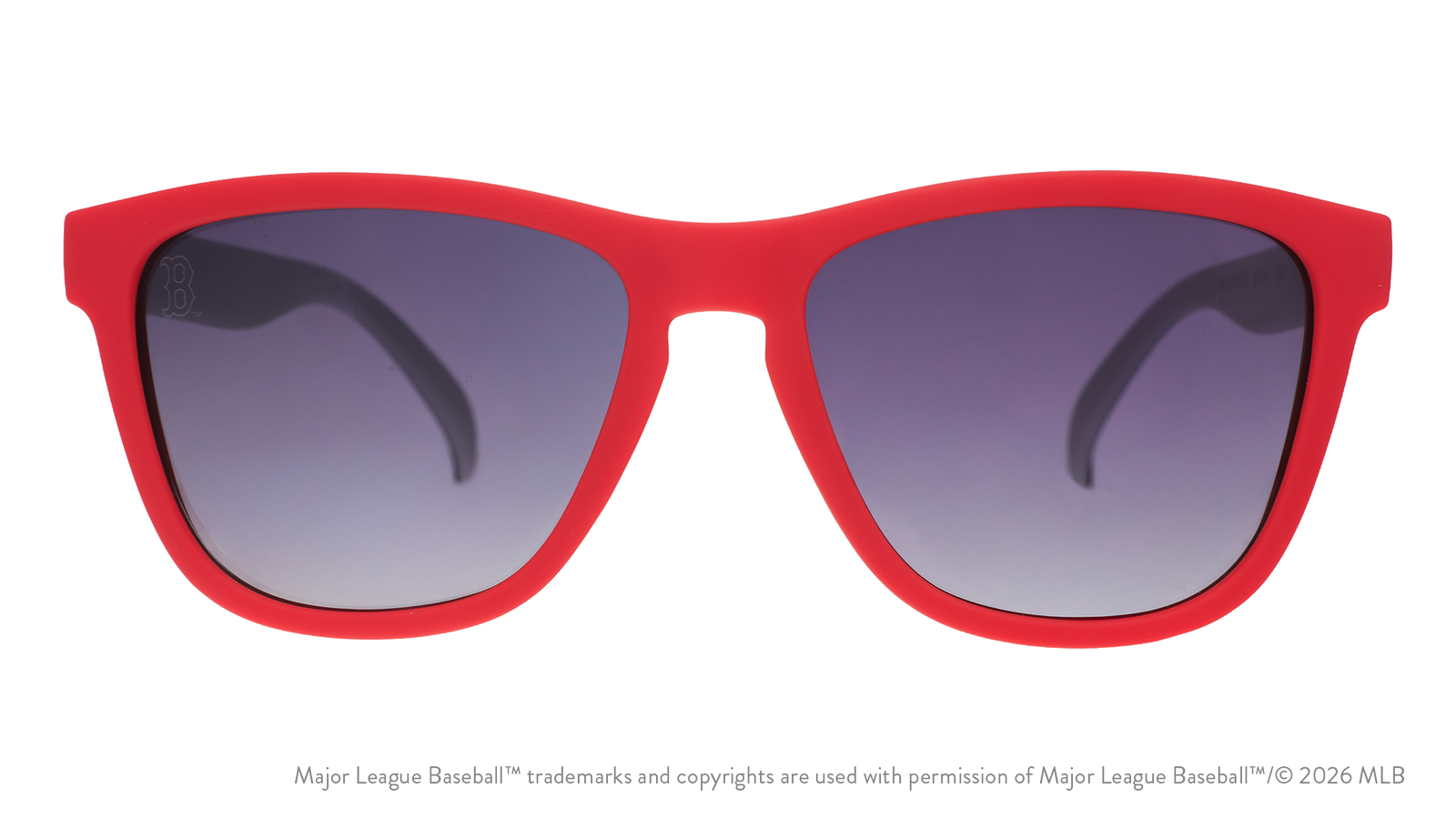 Red sunglasses with dark lenses on a white background. Available at Be Charmed