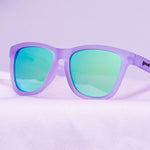 Front view of Lilac It Like That Goodr sunglasses with stylish purple frames, glare-reducing lenses, and no-slip grip—perfect for active wear; available at Be Charmed