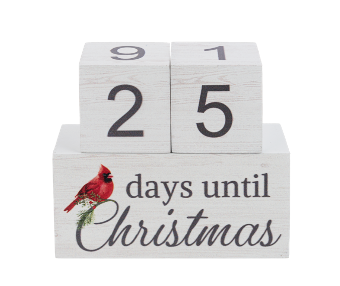 A wooden countdown calendar with numbers from 1 to 99 and a Christmas-themed design featuring a red bird on the front, titled '99 days until Christmas'. Available at Be Charmed
