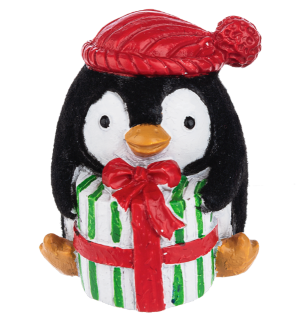 An adorable Ganz penguin charm token holding a gift. Available at Be Charmed