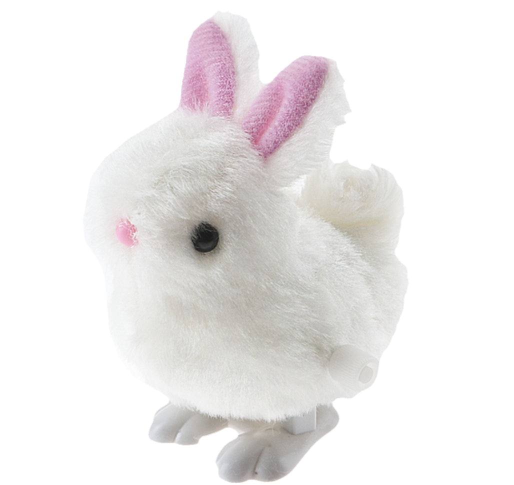 A white fluffy wind-up bunny toy with pink inner ears and a black eye detail on the front. Available at Be Charmed