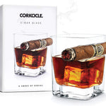 Glass and Box of orkcicle Cigar Glass – unique double old-fashioned whiskey glass with built-in cigar holder, designed for effortless sipping and smoking in one hand. A refined gift for cigar and whiskey lovers, available at Be Charmed.