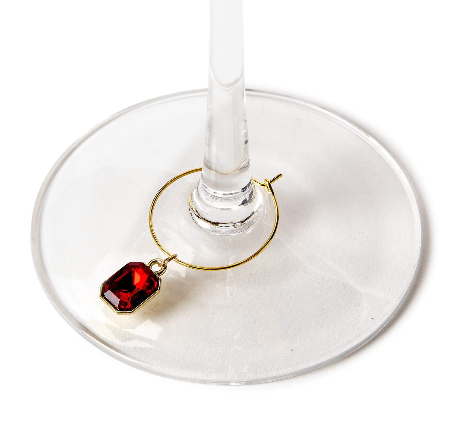 Wine glass with a red gemstone charm on a white background. Available at Be Charmed