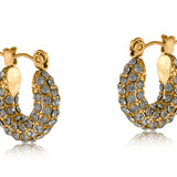 Gold Big Metal London Doris stone‑encrusted stainless steel stud earrings with shimmering crystal inlays, hypoallergenic surgical steel, ideal for sensitive ears. Available at Be Charmed
