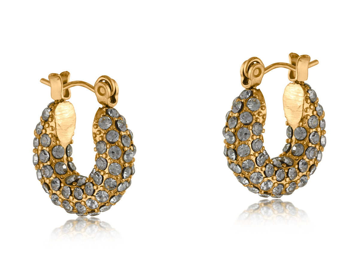 Gold Big Metal London Doris stone‑encrusted stainless steel stud earrings with shimmering crystal inlays, hypoallergenic surgical steel, ideal for sensitive ears. Available at Be Charmed