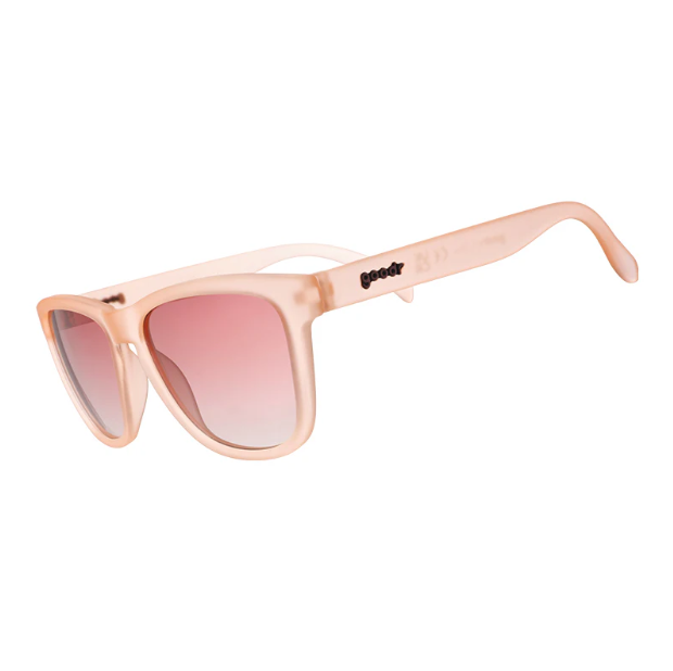 A pair of blush pink Goodr sunglasses with dusty pink gradient lenses.