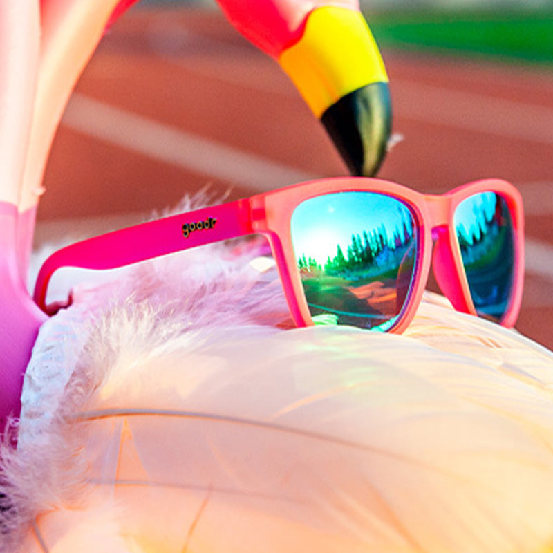 Close up of Goodr Flamingos on a Booze Cruise sunglasses with bright pink frames, polarized lenses, and no-slip grip—fun, functional eyewear at Be Charmed.