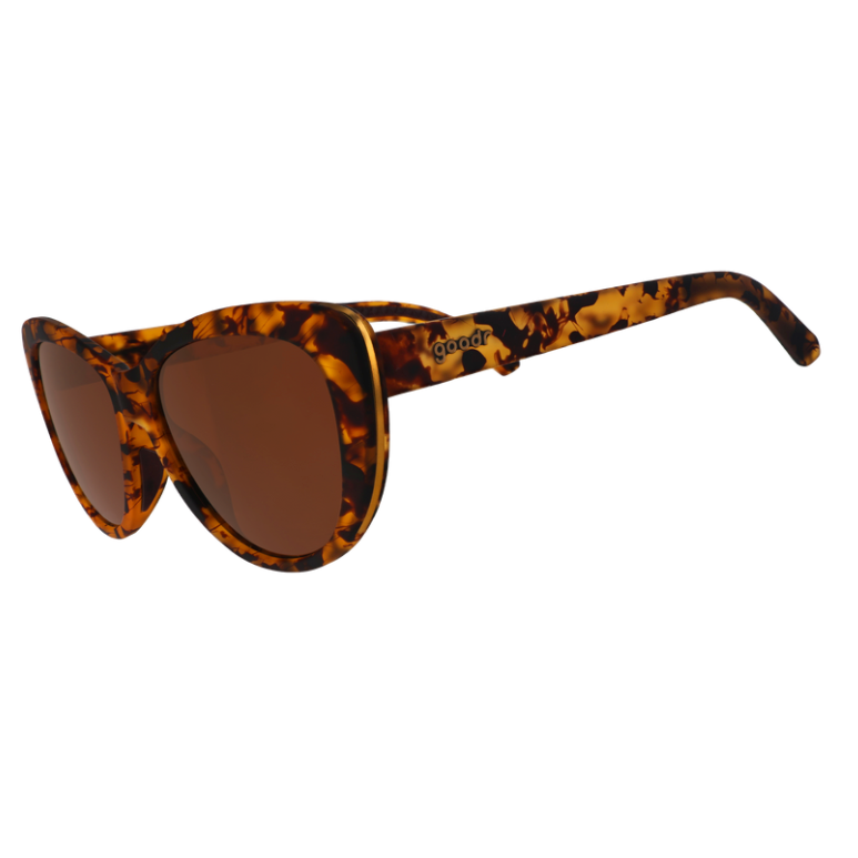 A pair of Goodr brown tortoiseshell sunglasses with gold accents and brown non-reflective lenses. Available at Be Charmed