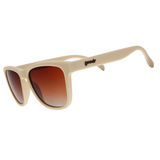 A pair of beige sunglasses with orange-gold gradient lenses, branded with 'goodr' on the side. Available at Be Charmed
