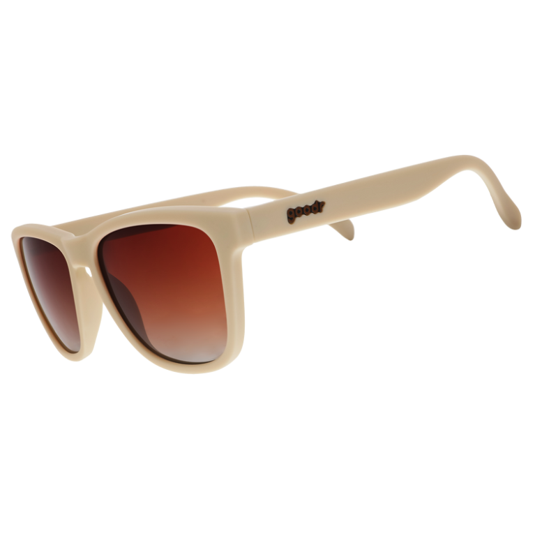 A pair of beige sunglasses with orange-gold gradient lenses, branded with 'goodr' on the side. Available at Be Charmed