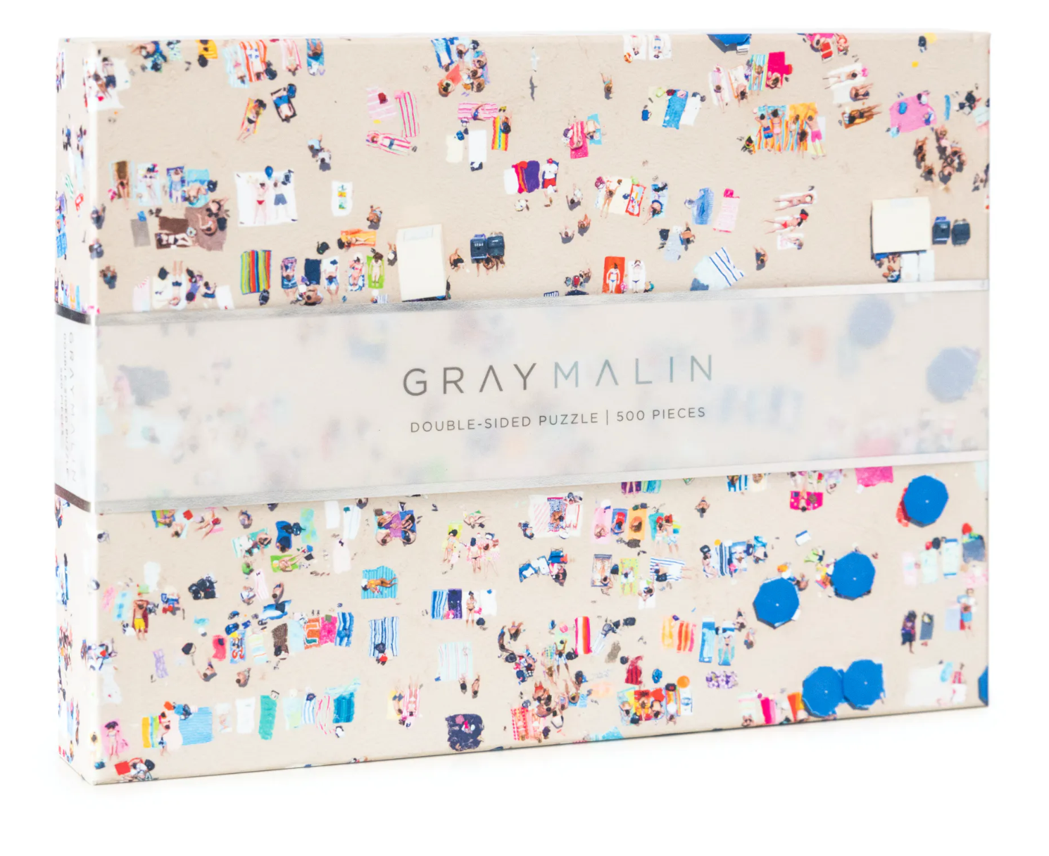 A puzzle box with a beach theme on one side and an ocean reef on the other, with the brand 'Gray Malin' printed on the box. Available at Be Charmed