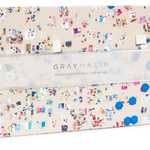 A puzzle box with a beach theme on one side and an ocean reef on the other, with the brand 'Gray Malin' printed on the box. Available at Be Charmed