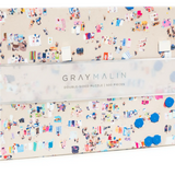 A puzzle box with a beach theme on one side and an ocean reef on the other, with the brand 'Gray Malin' printed on the box. Available at Be Charmed