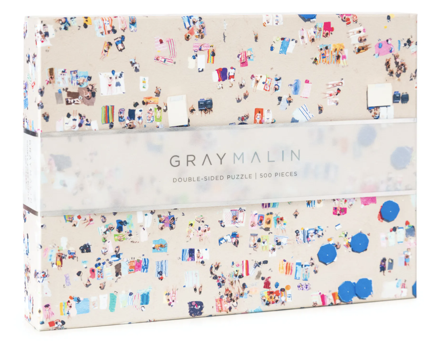A puzzle box with a beach theme on one side and an ocean reef on the other, with the brand 'Gray Malin' printed on the box. Available at Be Charmed