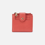 Pink mirage Hobo wallet with gold accents on a white background. Available at Be Charmed