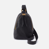 Black leather Hobo Sling bag with gold zipper on a white background. Available at Be Charmed