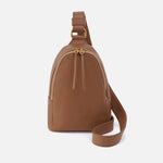 Timber Brown leather HOBO sling bag on a white background. Available at Be Charmed