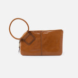 Truffle HOBO leather clutch with a round handle on a white background. Available at Be Charmed