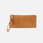 Natural leather HOBO wristlet with wrist strap on a white background. Available at Be Charmed