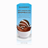 Packaging of Hammond's Hot Chocolate Snowballs featuring an image of a chocolate snowball with marshmallows visible, against a blue background. Available at Be Charmed