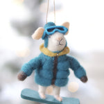 Decorative ornament of a mouse in winter clothing hanging against a blurred snowy background. Available at Be Charmed