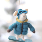 Decorative ornament of a mouse in winter clothing hanging against a blurred snowy background. Available at Be Charmed