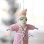Person holding a plush mouse ornament in a pink robe with green glasses, hanging against a blurred background. Available at Be Charmed