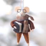 Felt mouse ornament with glasses and a scarf hanging against a blurred natural background. Available at Be Charmed