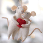 Two mouse ornaments holding a red heart against a blurred background. Available at Be Charmed