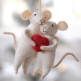 Two mouse ornaments holding a red heart against a blurred background. Available at Be Charmed
