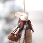Felted mouse ornament with plaid dress and scarf, held against a blurred snowy background. Available at Be Charmed