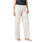 Person wearing white pajama pants with a colorful pattern on a white background. Available at Be Charmed