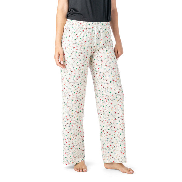 Person wearing white pajama pants with a colorful pattern on a white background. Available at Be Charmed