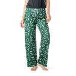 Green pajama pants with candy cane pattern worn by a person on a white background. Available at Be Charmed