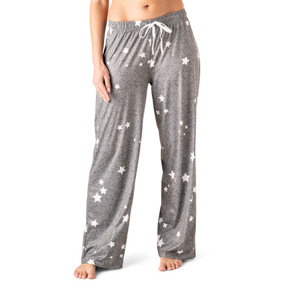 Gray pajama pants with white star pattern worn by a person on a white background. Available at Be Charmed