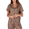 Woman wearing a leopard print pajama top on a white background. Available at Be Charmed