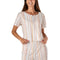 Woman wearing a striped pajama set on a white background. Available atBe Charmed