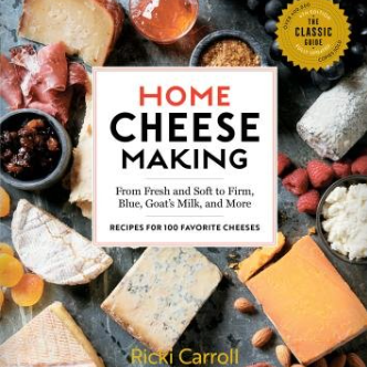 Book cover of 'Home Cheese Making' with cheese and ingredients on a dark surface. Available at Be Charmed