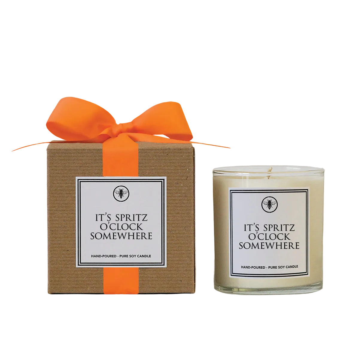 Ella B Candle labeled 'It's Spritz O'Clock Somewhere' with a matching box and orange ribbon on a white gray background. Available at Be Charmed