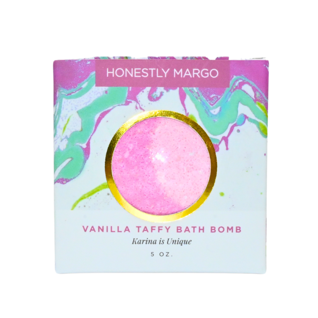 Honestly Margo Vanilla Taffy Bath Bomb packaging with pink bath bomb on a white background. Available at Be Charmed