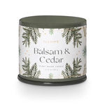 Candle with 'Balsam & Cedar' label on a white background. Available at Be Charmed