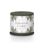Candle with 'Balsam & Cedar' label on a white background. Available at Be Charmed