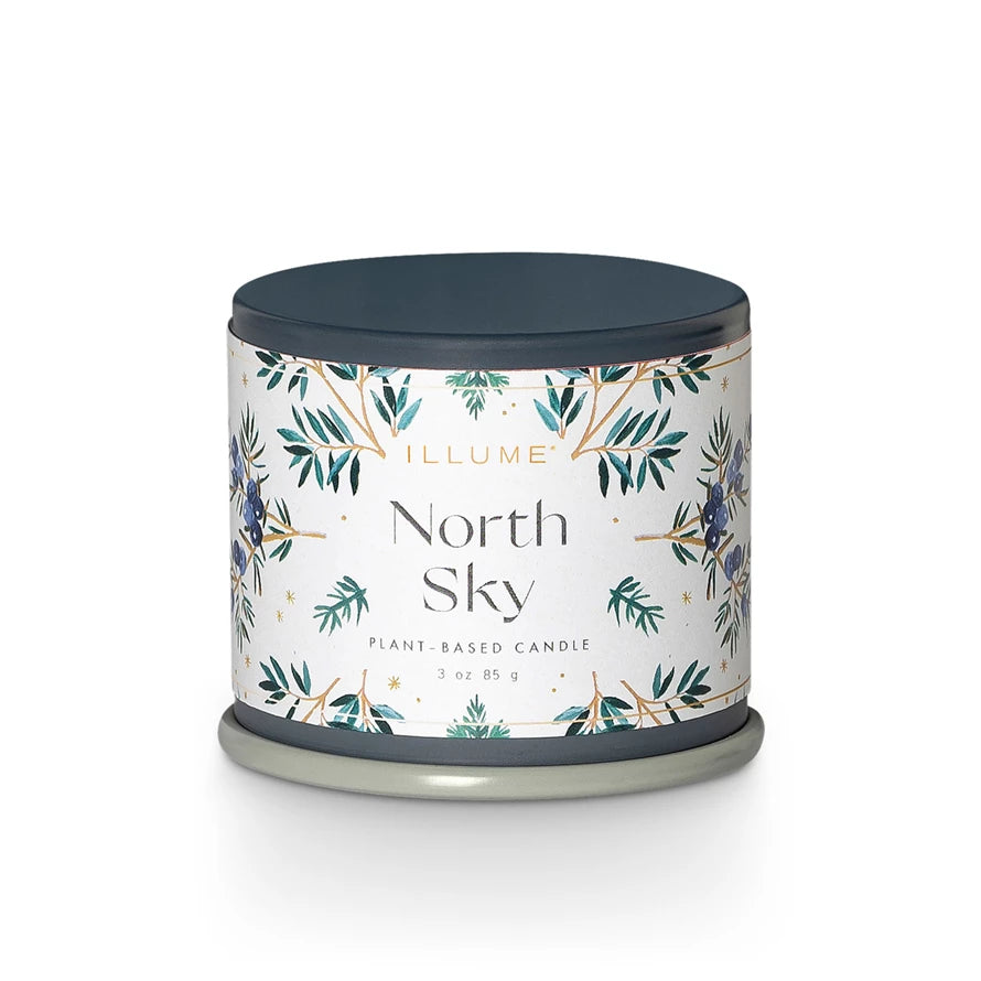 Candle with 'North Sky' label and leaf design on a white background. Available at Be Charmed.