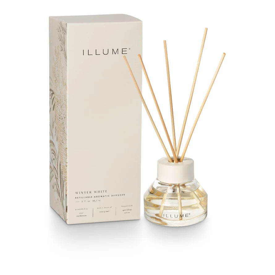 ILLUME diffuser bottle with reeds and packaging on a white background. Available at Be Charmed