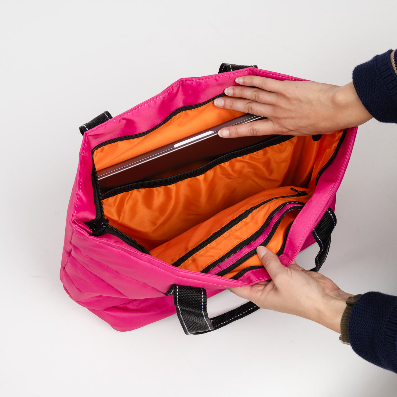 Inside of Pink Puffer SCOUT Layover Tote – quilted puffer travel tote (19″ W × 13″ H × 5.5″ D), interior zipper compartments, reinforced bottom, folds flat. Available at Be Charmed