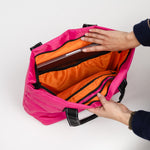 Inside of Pink Puffer SCOUT Layover Tote – quilted puffer travel tote (19″ W × 13″ H × 5.5″ D), interior zipper compartments, reinforced bottom, folds flat. Available at Be Charmed