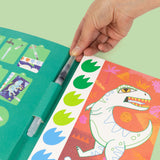 inside of Tiger Tribe Paint a Picture Dinosaurs art kit with watercolor paints, brush, palette, and dinosaur-themed painting scenes. Creative gift for kids. Available at Be Charmed.